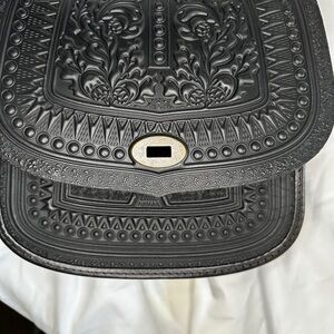 Tooled black leather saddle/messenger bag.